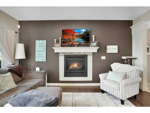 11 Henderson Close, Penhold, AB - Indoor Photo Showing Living Room With Fireplace