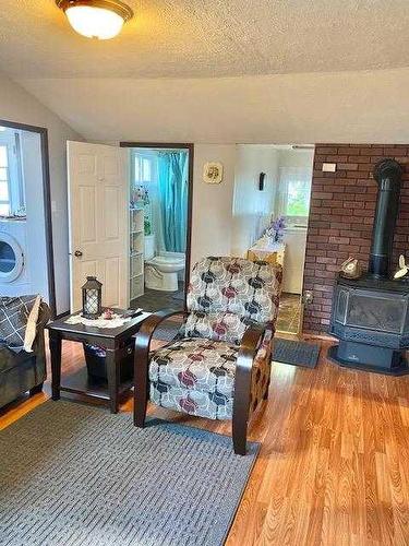 5007 48 Street, Hardisty, AB - Indoor Photo Showing Living Room With Fireplace