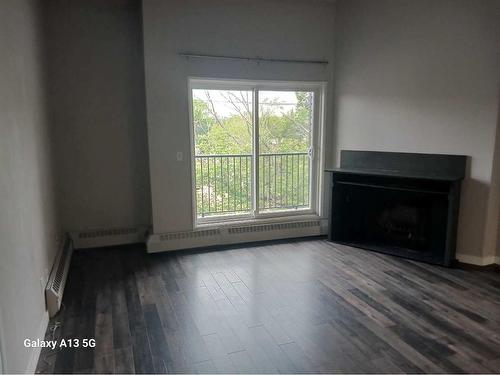 307-4405 48 Avenue, Red Deer, AB - Indoor Photo Showing Living Room With Fireplace