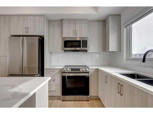 332-903 Mahogany Boulevard Se, Calgary, AB - Indoor Photo Showing Kitchen With Double Sink With Upgraded Kitchen