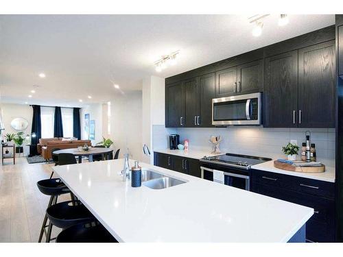 199 Vantage Drive Drive, Cochrane, AB - Indoor Photo Showing Kitchen With Double Sink With Upgraded Kitchen