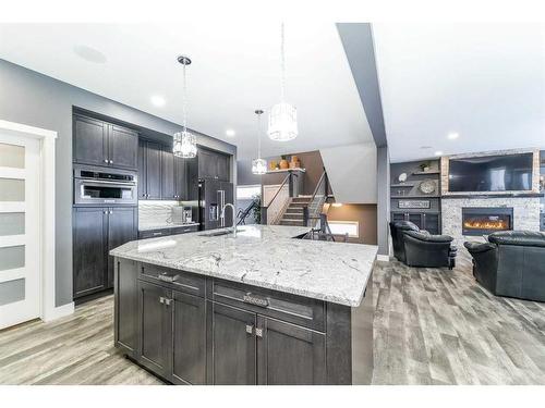 75 Valli Close, Sylvan Lake, AB - Indoor Photo Showing Kitchen With Fireplace With Upgraded Kitchen