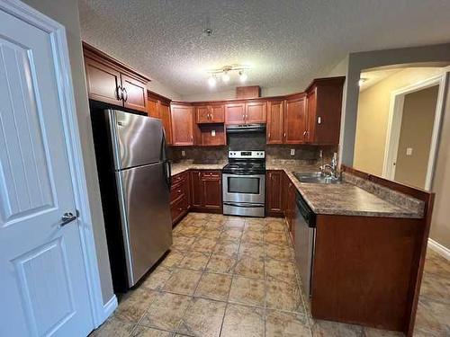 205-5204 52 Avenue, Tofield, AB - Indoor Photo Showing Kitchen With Double Sink