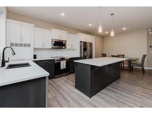 137 Hampton Crescent, Sylvan Lake, AB - Indoor Photo Showing Kitchen With Double Sink With Upgraded Kitchen