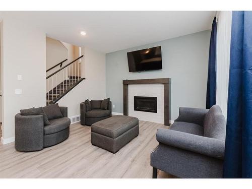 137 Hampton Crescent, Sylvan Lake, AB - Indoor Photo Showing Living Room With Fireplace