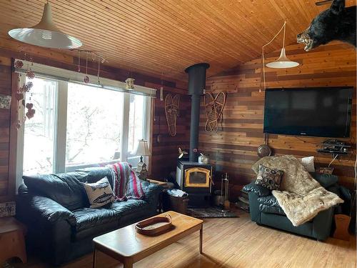 1303 Baptiste Drive, West Baptiste, AB - Indoor Photo Showing Living Room With Fireplace