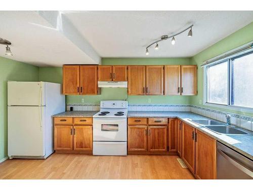 32 Mcblane Close, Red Deer, AB - Indoor Photo Showing Kitchen With Double Sink