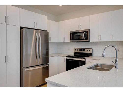 2095 Fowler Road Sw, Airdrie, AB - Indoor Photo Showing Kitchen With Double Sink With Upgraded Kitchen