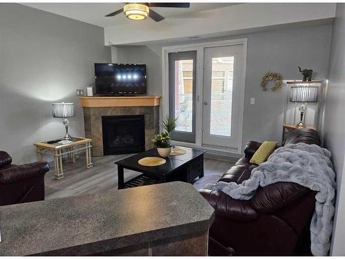 #116-5040 53 Street, Sylvan Lake, AB - Indoor Photo Showing Living Room With Fireplace