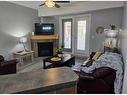 #116-5040 53 Street, Sylvan Lake, AB  - Indoor Photo Showing Living Room With Fireplace 