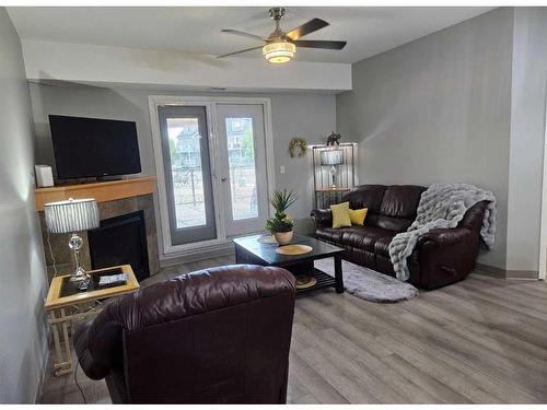 #116-5040 53 Street, Sylvan Lake, AB - Indoor Photo Showing Living Room With Fireplace