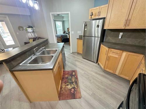 #116-5040 53 Street, Sylvan Lake, AB - Indoor Photo Showing Kitchen With Double Sink