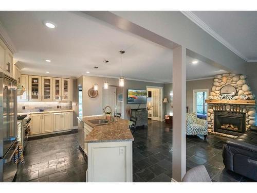 1709 Pratridge Drive, Rural Camrose County, AB - Indoor Photo Showing Kitchen With Fireplace With Double Sink