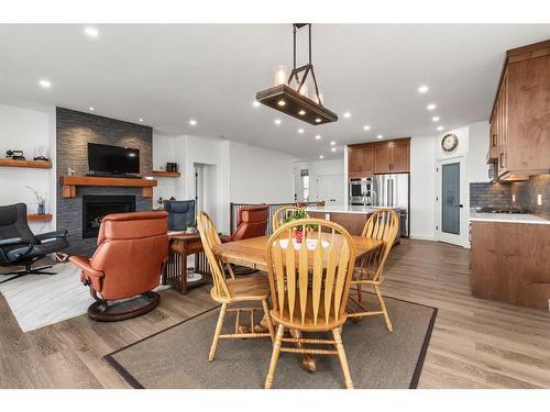 16 Vireo Avenue, Olds, AB - Indoor Photo Showing Dining Room With Fireplace