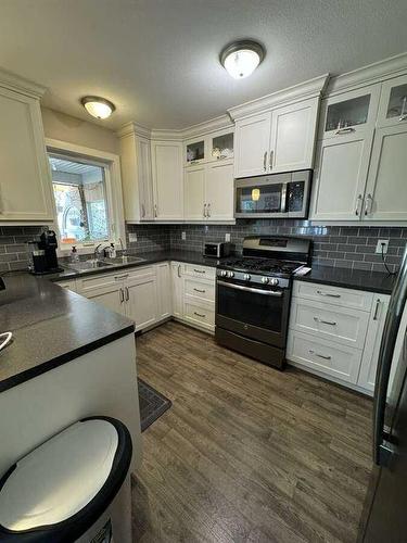 413 10B Street, Nobleford, AB - Indoor Photo Showing Kitchen With Double Sink