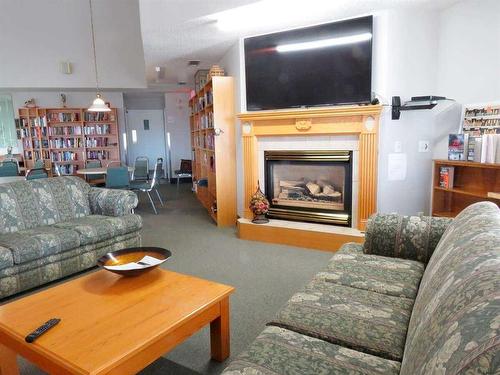 3118-3000 Sienna Park Green Sw, Calgary, AB - Indoor Photo Showing Living Room With Fireplace