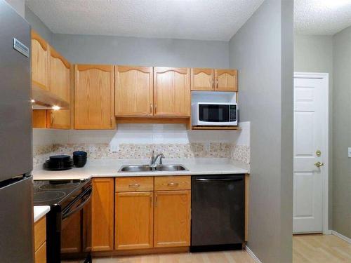 3118-3000 Sienna Park Green Sw, Calgary, AB - Indoor Photo Showing Kitchen With Double Sink