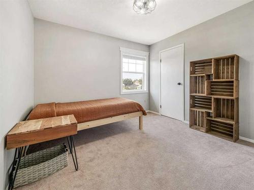 205 South 150 Street West, Raymond, AB - Indoor Photo Showing Bedroom