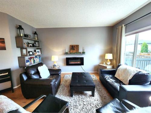 22 Jewell Street, Red Deer, AB - Indoor Photo Showing Living Room With Fireplace