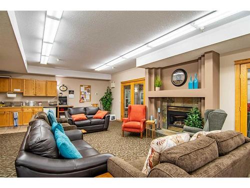 325-4512 52 Avenue, Red Deer, AB - Indoor Photo Showing Living Room With Fireplace