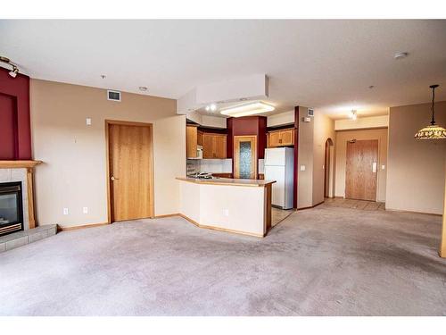 325-4512 52 Avenue, Red Deer, AB - Indoor Photo Showing Kitchen With Fireplace