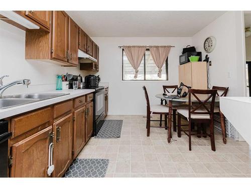 100 Mclevin Crescent, Red Deer, AB - Indoor Photo Showing Kitchen With Double Sink