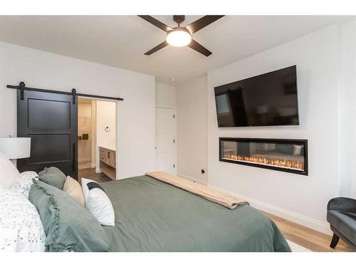 34 Longmire Close, Red Deer, AB - Indoor Photo Showing Bedroom With Fireplace