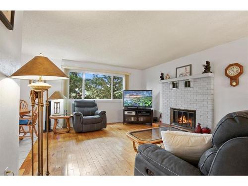 32 Rutherford Drive, Red Deer, AB - Indoor Photo Showing Living Room With Fireplace