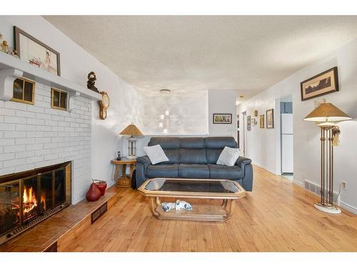 32 Rutherford Drive, Red Deer, AB - Indoor Photo Showing Living Room With Fireplace