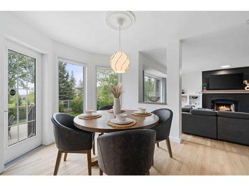 14306 Evergreen Street Sw, Calgary, AB - Indoor Photo Showing Dining Room With Fireplace