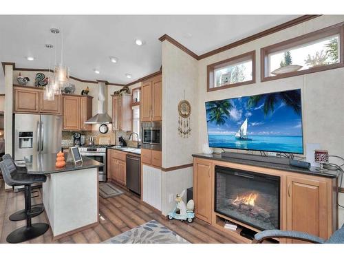 140-10032 Township Road 422, Rural Ponoka County, AB - Indoor Photo Showing Kitchen With Fireplace