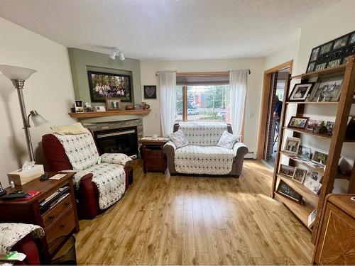 118-4805 45 Street, Red Deer, AB - Indoor Photo Showing Living Room With Fireplace