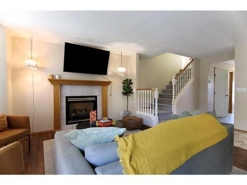 5015 48 Street, Sylvan Lake, AB - Indoor Photo Showing Living Room With Fireplace