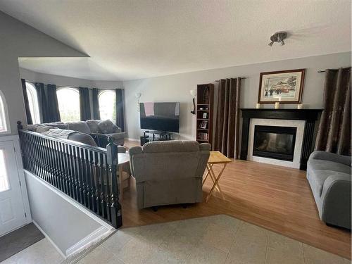 4607 4A Street South, Boyle, AB - Indoor Photo Showing Living Room With Fireplace