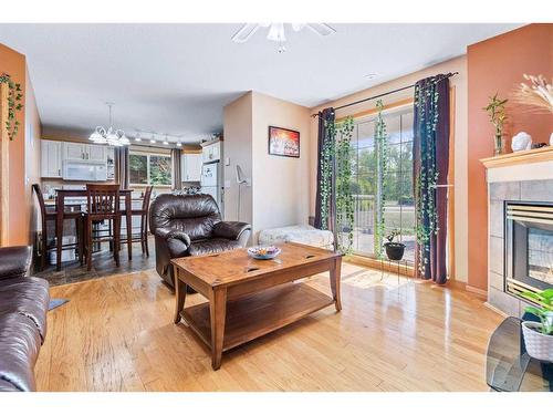 101-5510 Kerry Wood Drive, Red Deer, AB - Indoor Photo Showing Living Room With Fireplace