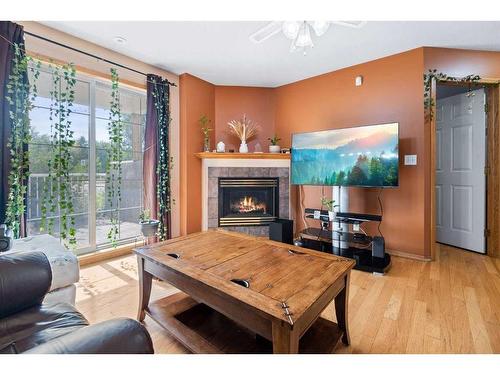 101-5510 Kerry Wood Drive, Red Deer, AB - Indoor Photo Showing Living Room With Fireplace