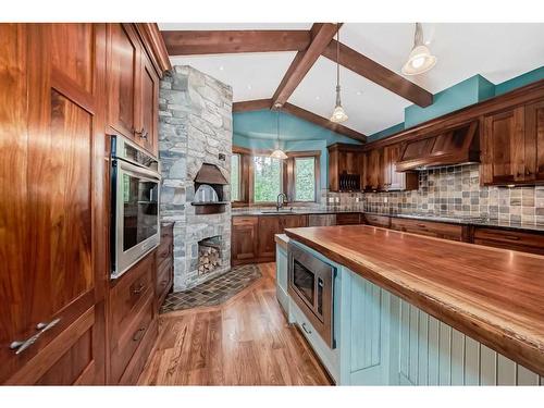 12 Cronquist Close, Red Deer, AB - Indoor Photo Showing Kitchen With Fireplace