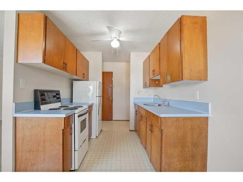 101-303-5134 43 Street, Red Deer, AB - Indoor Photo Showing Kitchen With Double Sink