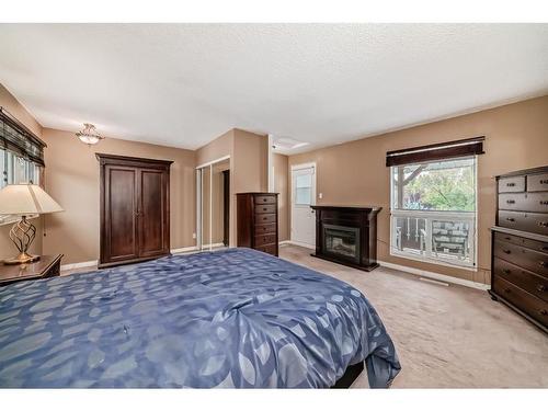 23 Stirling Close, Red Deer, AB - Indoor Photo Showing Bedroom With Fireplace