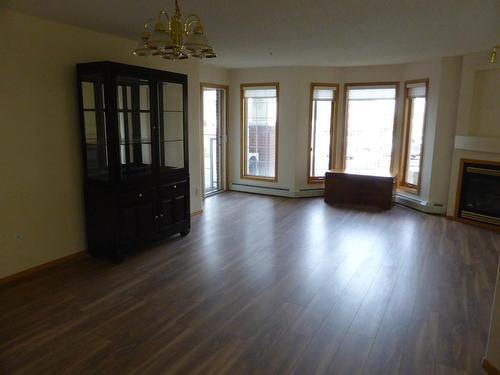 105-4805 45 Street, Red Deer, AB - Indoor Photo Showing Living Room With Fireplace