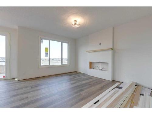 28 Key Cove Sw, Airdrie, AB - Indoor Photo Showing Living Room With Fireplace