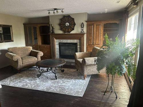 3823 51 Avenue Close, Ponoka, AB - Indoor Photo Showing Living Room With Fireplace