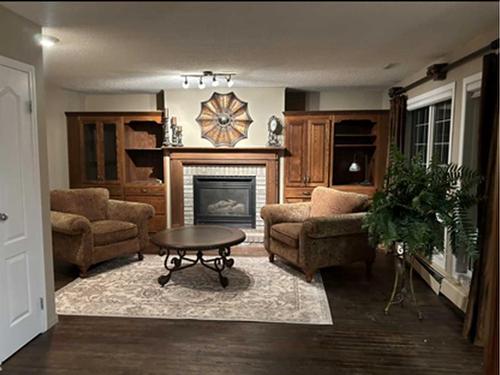 3823 51 Avenue Close, Ponoka, AB - Indoor Photo Showing Living Room With Fireplace