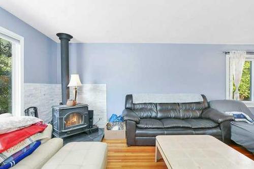 3515 45 Avenue, Red Deer, AB - Indoor Photo Showing Living Room With Fireplace