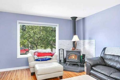 3515 45 Avenue, Red Deer, AB - Indoor Photo Showing Living Room With Fireplace