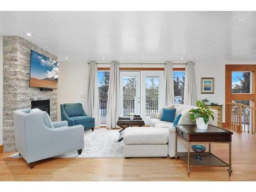 15 Rustic Crescent, Norglenwold, AB - Indoor Photo Showing Living Room With Fireplace