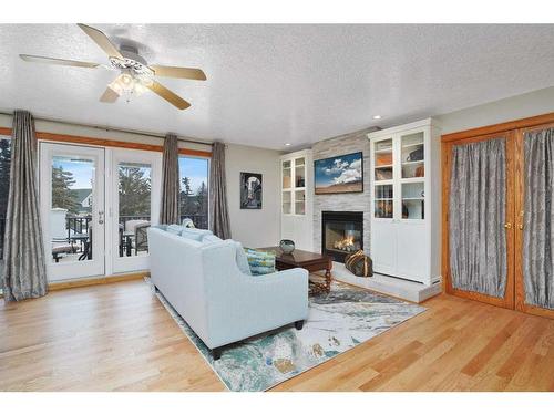 15 Rustic Crescent, Norglenwold, AB - Indoor Photo Showing Living Room With Fireplace