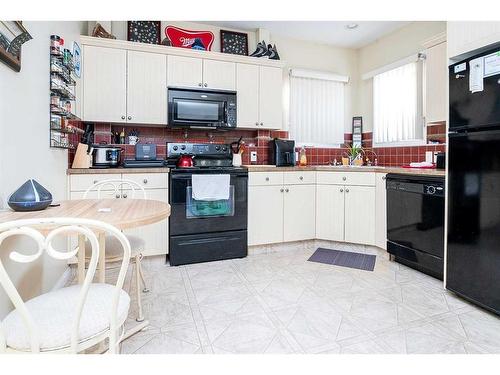 2 Mackenzie Crescent, Lacombe, AB - Indoor Photo Showing Kitchen With Double Sink