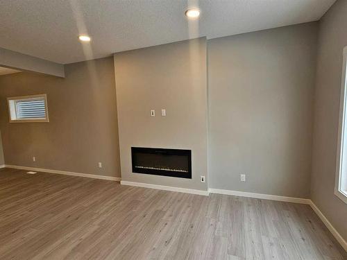 84 Key Cove Sw, Airdrie, AB - Indoor With Fireplace