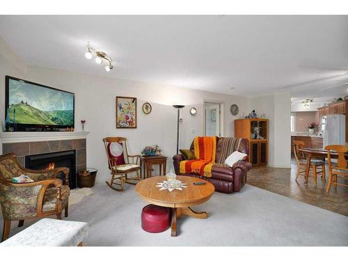 306-4425 Heritage Way, Lacombe, AB - Indoor Photo Showing Living Room With Fireplace